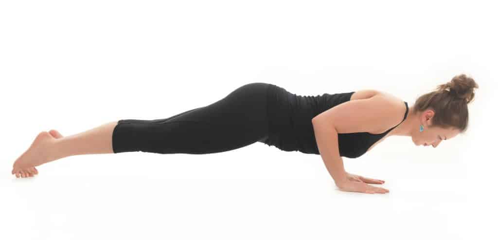 Image of a woman doing Chaturanga Dandasana, the Yoga variation of a pushup