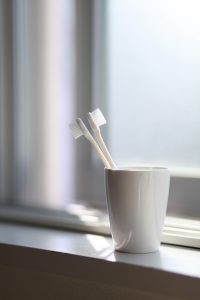 Image of two white toothbrushes, symbolising a potential trigger to start your yoga practice at home