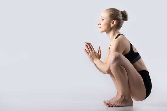 Image of a woman in the yogic squat